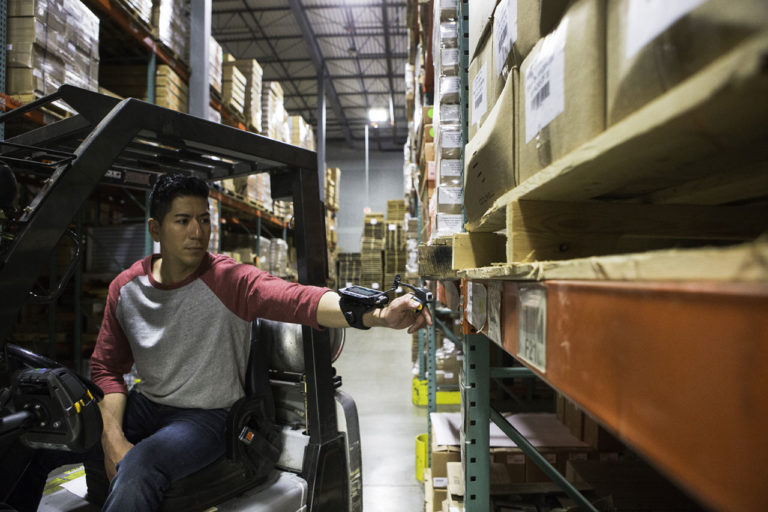 Worker Scanning Warehouse Barcode Label using an RFID Reader